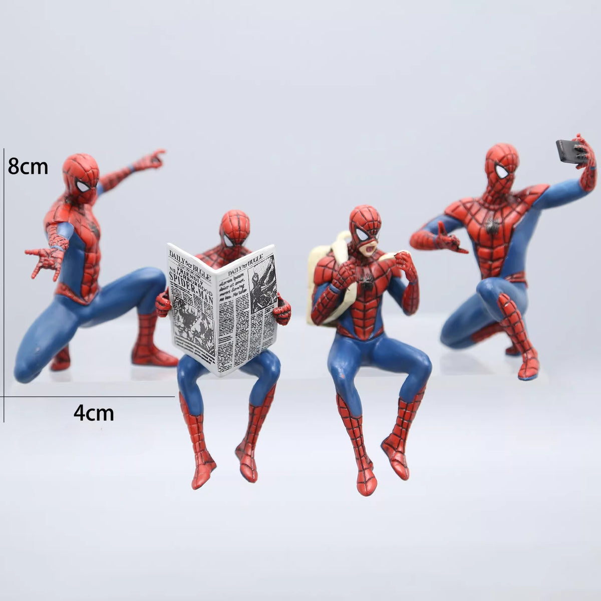 Four Spider-Man action figures in different poses on a light gray background