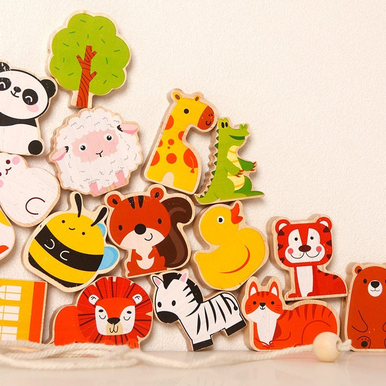 Collection of colorful animal wooden toys on a beige background