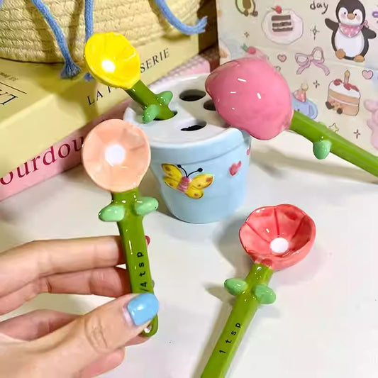 Colorful baby teething toy with a hand holding one of the components, set against a light background.