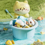 Toy bucket with cat-shaped lid filled with small toys in a pool with grass background