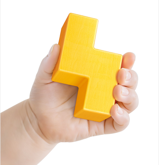 Hand holding a yellow letter 'H' block against a white background