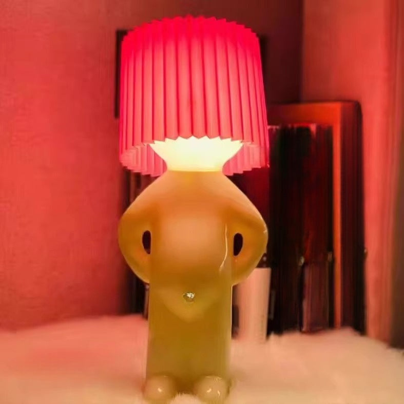 Novelty lamp shaped like a dog with a pink lampshade on a red background