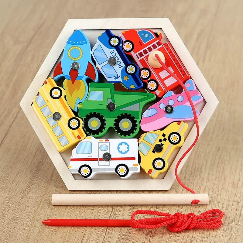 Colorful wooden toy set with vehicles in a hexagonal wooden box on a wooden surface.