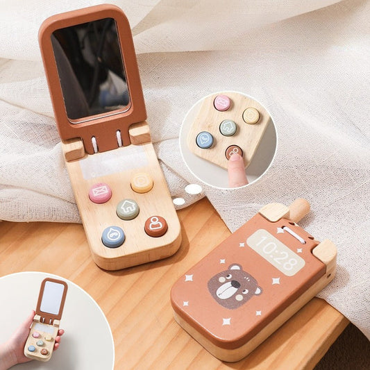 Wooden toy phone with colorful buttons and a mirror on a wooden surface.