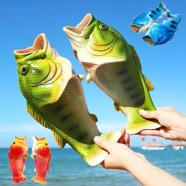 Colorful fish-shaped slippers held by hands with a blue sky and ocean background.
