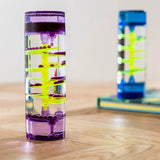 Colorful cylindrical water bottle with a unique design on a wooden surface
