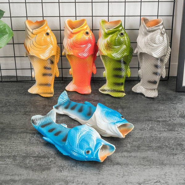 Colorful fish-shaped slippers on a tiled floor.