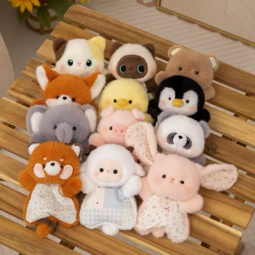 Collection of small animal plush toys on a wooden surface