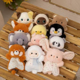 Collection of small animal plush toys on a wooden surface