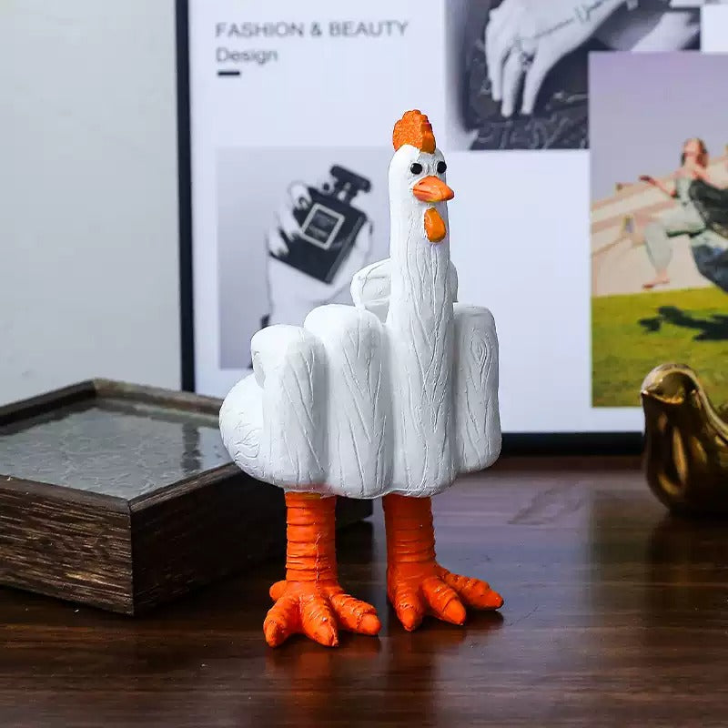 White rubber chicken toy with orange feet and comb on a wooden surface.