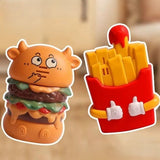 Two novelty items shaped like a hamburger and a container of fries on a beige background.
