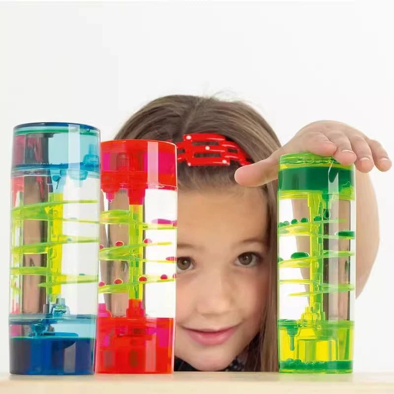 Colorful marble run toys with a child holding one of them