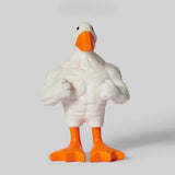 White goose figurine with orange feet and beak on a light gray background