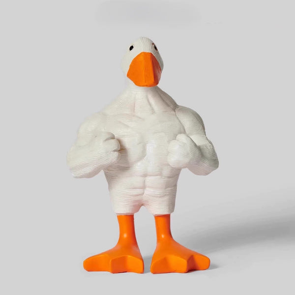 White goose figurine with orange feet and beak on a light gray background